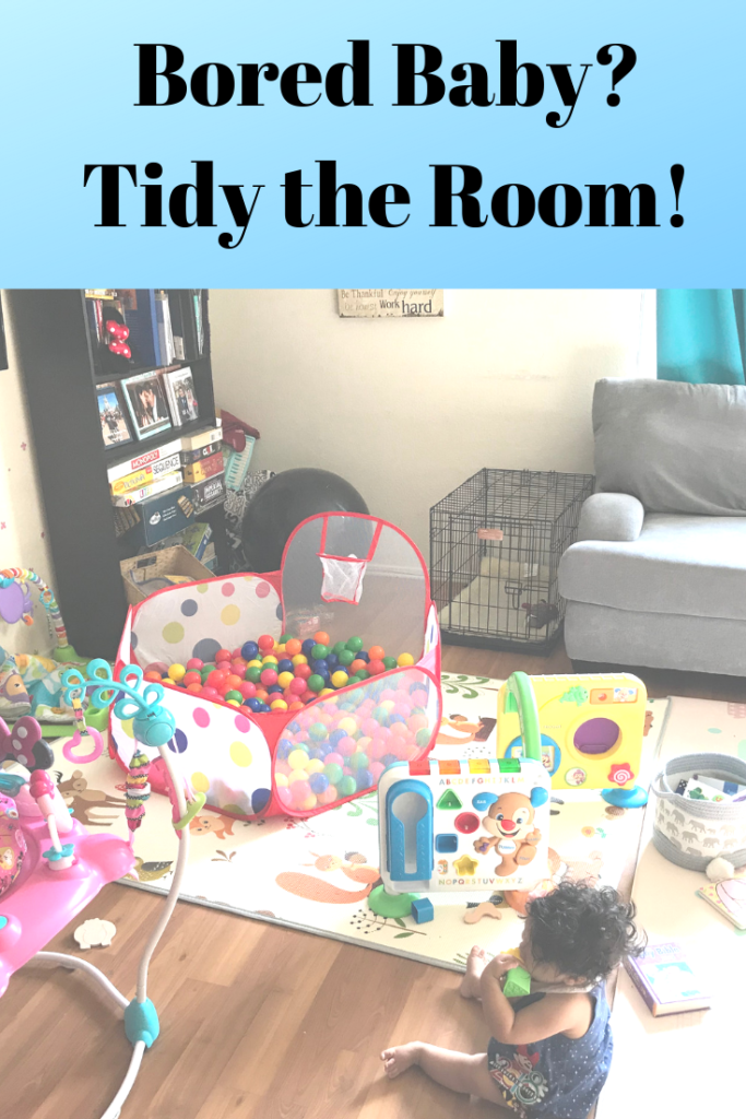 a messy family living room with toys, bookcases, mats, and a ball pit in it with text "bored baby? tidy the room!"