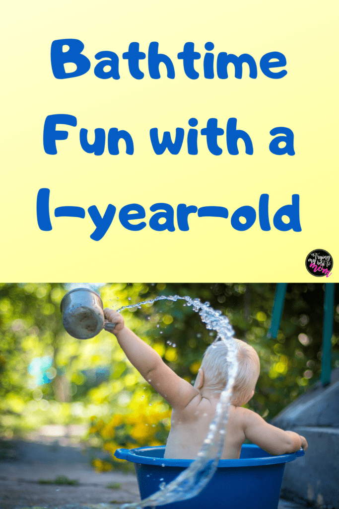 a baby throwing water out of a bathtub outside with text bathtime fun with a 1-year-old