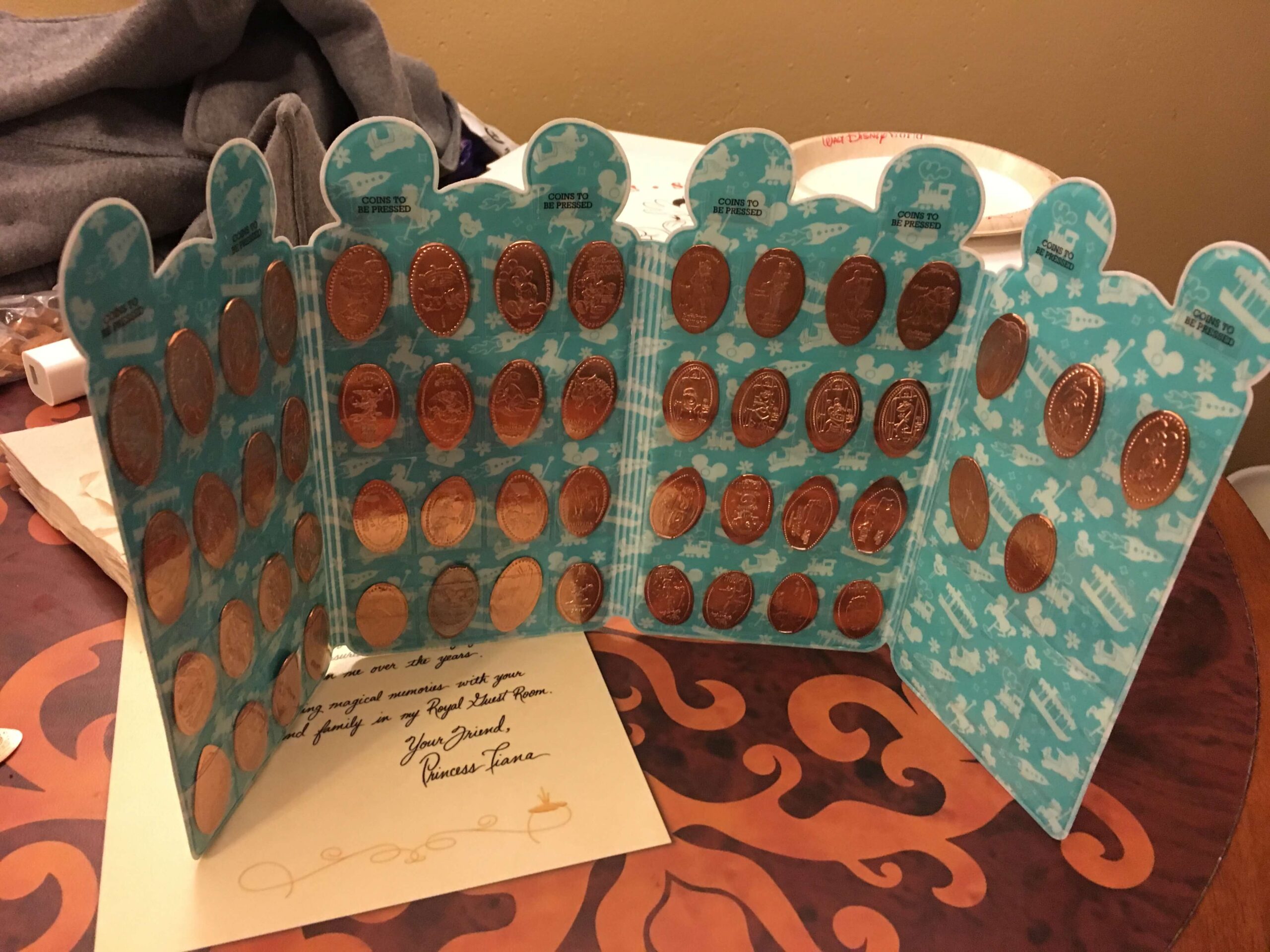 A pressed penny collection sitting in a pressed penny holder book