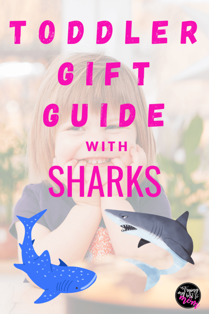 toddler smiling with text gift guide for shark loving toddlers
