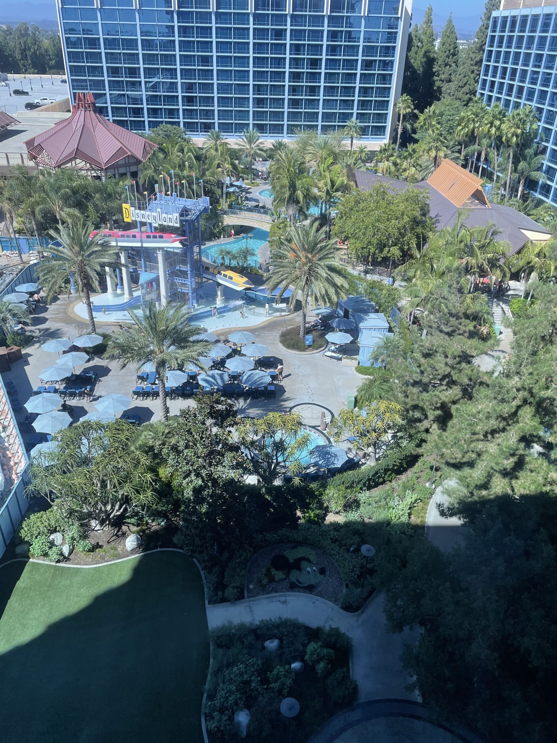 a view from a high window of the disneyland hotel pool area