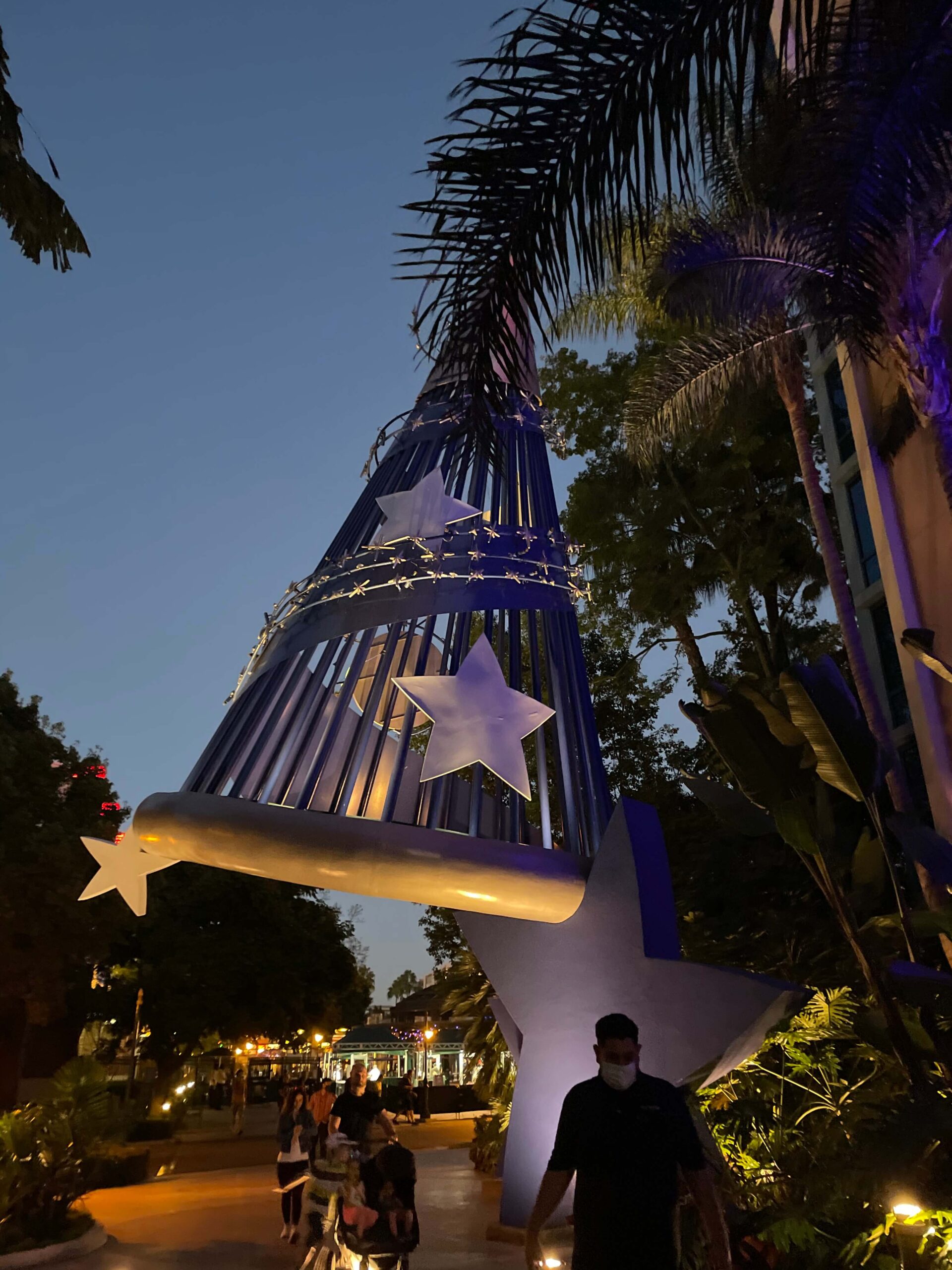 sorcerer mickey hat outside of the disneyland hotel at night