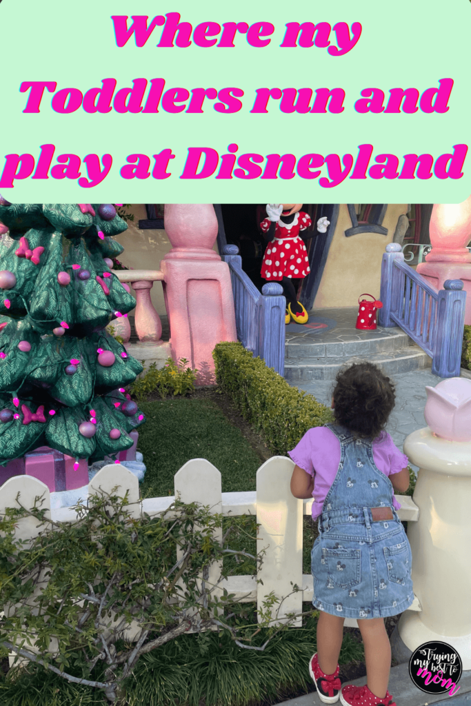 a little toddler girl looking at minnie mouse waving from her house in toontown with title where my toddlers run and play at disneyland